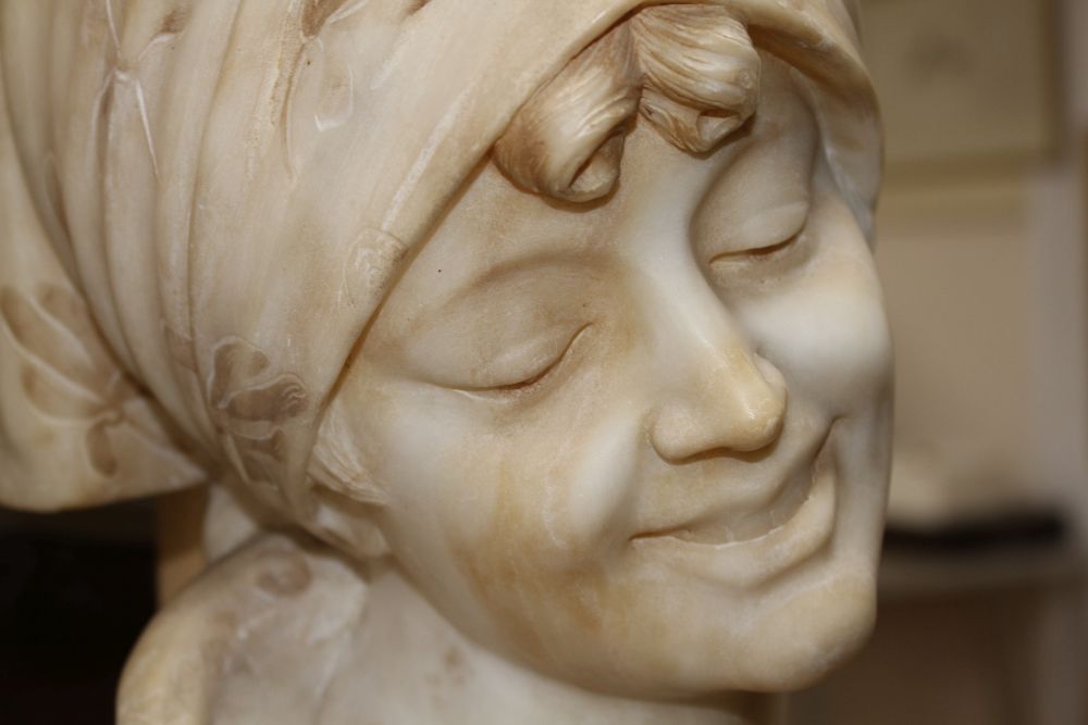 G. Pineschi (Italian c.1900). A carved alabaster and rose quartz bust of an Italian woman, H.22in.